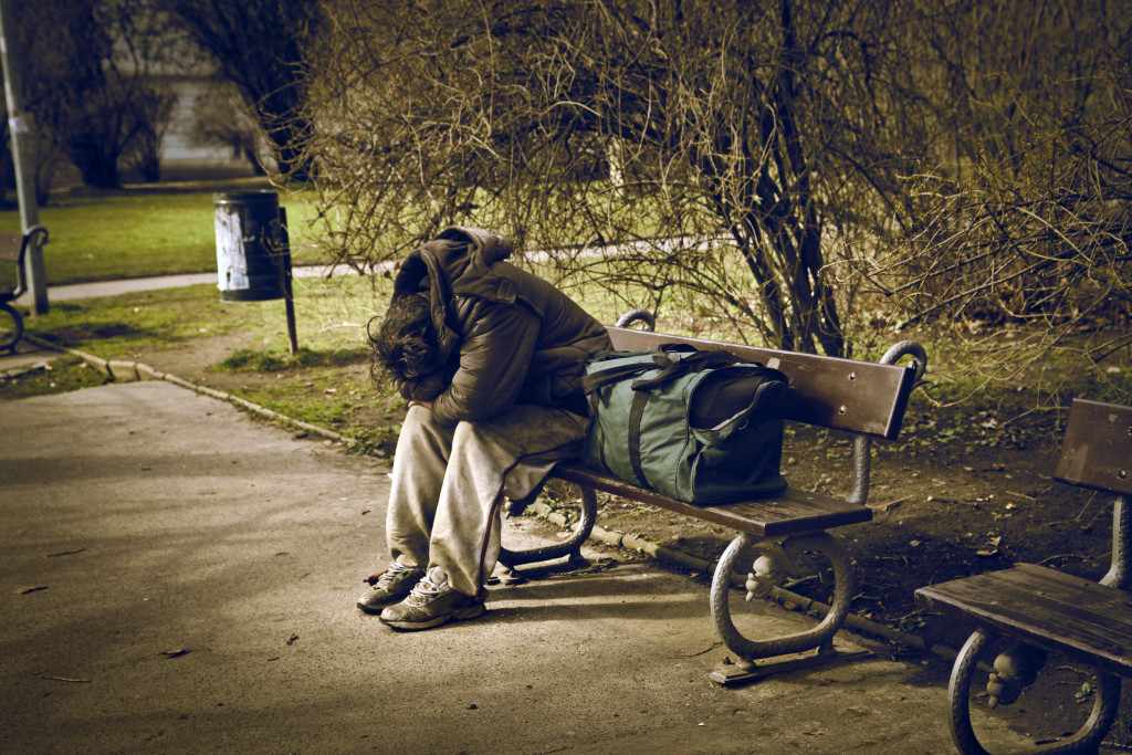 homeless man on a park bench