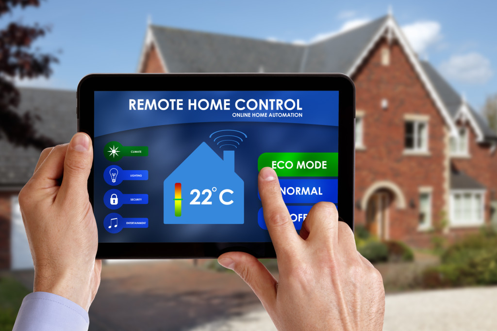 Holding a smart energy controller or remote home control online home automation system on a digital tablet