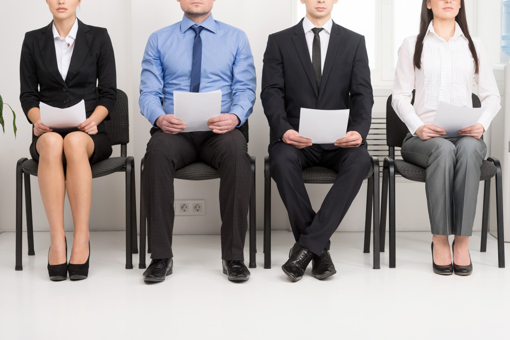 four male and female applicants seated while waiting for the interview